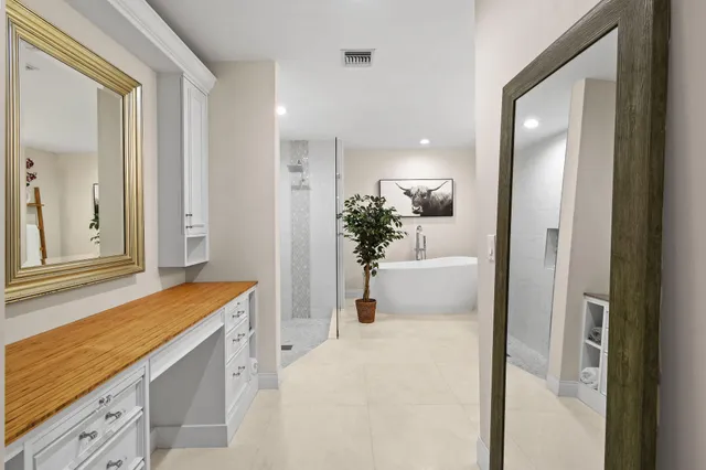 a bedroom with a bed and a large mirror