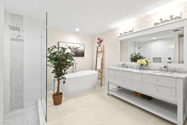 a bathroom with a tub sink and mirror