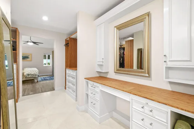 a spacious bathroom with a sink and a mirror