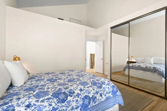 a bedroom with a bed and a mirror