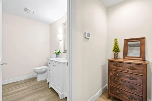 a bathroom with a granite countertop toilet and a sink