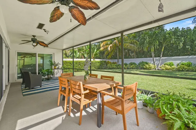 a view of a porch with furniture and garden
