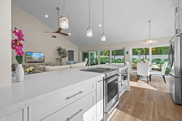 a kitchen with stainless steel appliances granite countertop a stove and a wooden floors