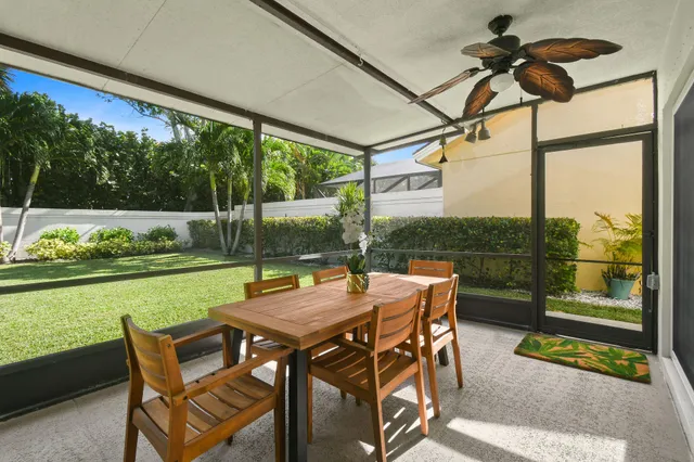 a view of a patio with a table chairs and backyard
