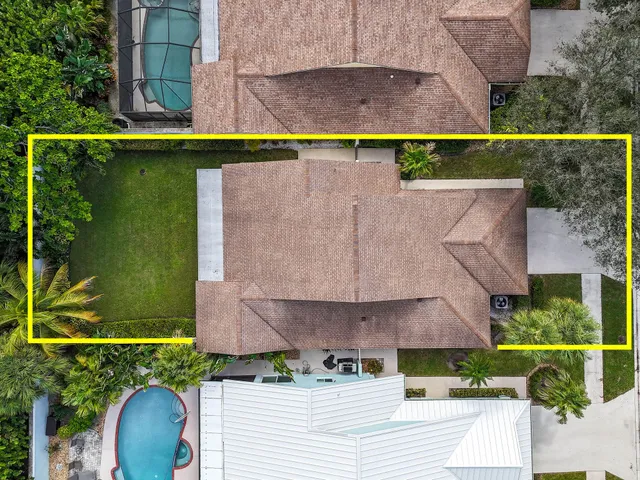 an aerial view of a house with a garden and swimming pool