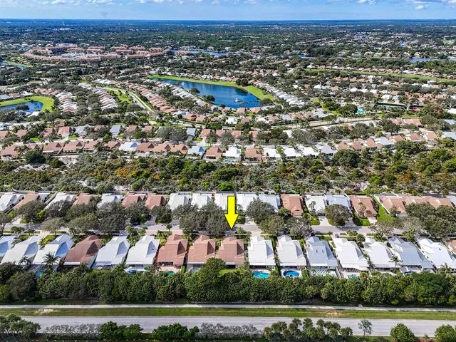 an aerial view of residential houses with outdoor space and parking