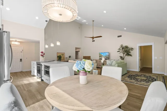 a dining room with furniture and a chandelier