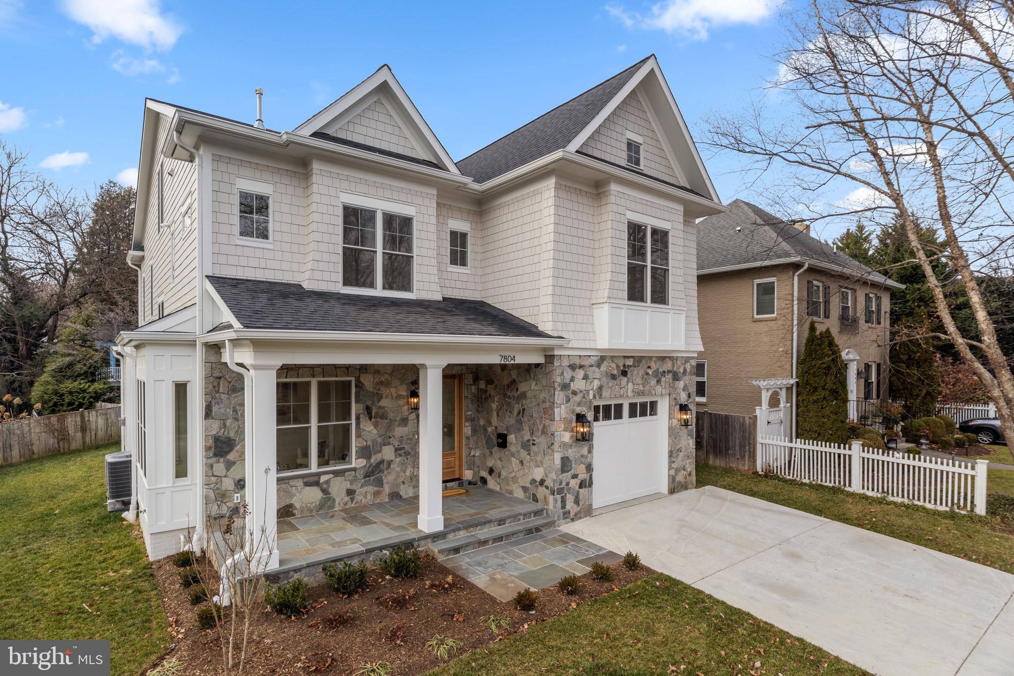 7804 Custer Road Bethesda, MD 20814 - Photo 2 of 68 a front view of a house with a yard and garage