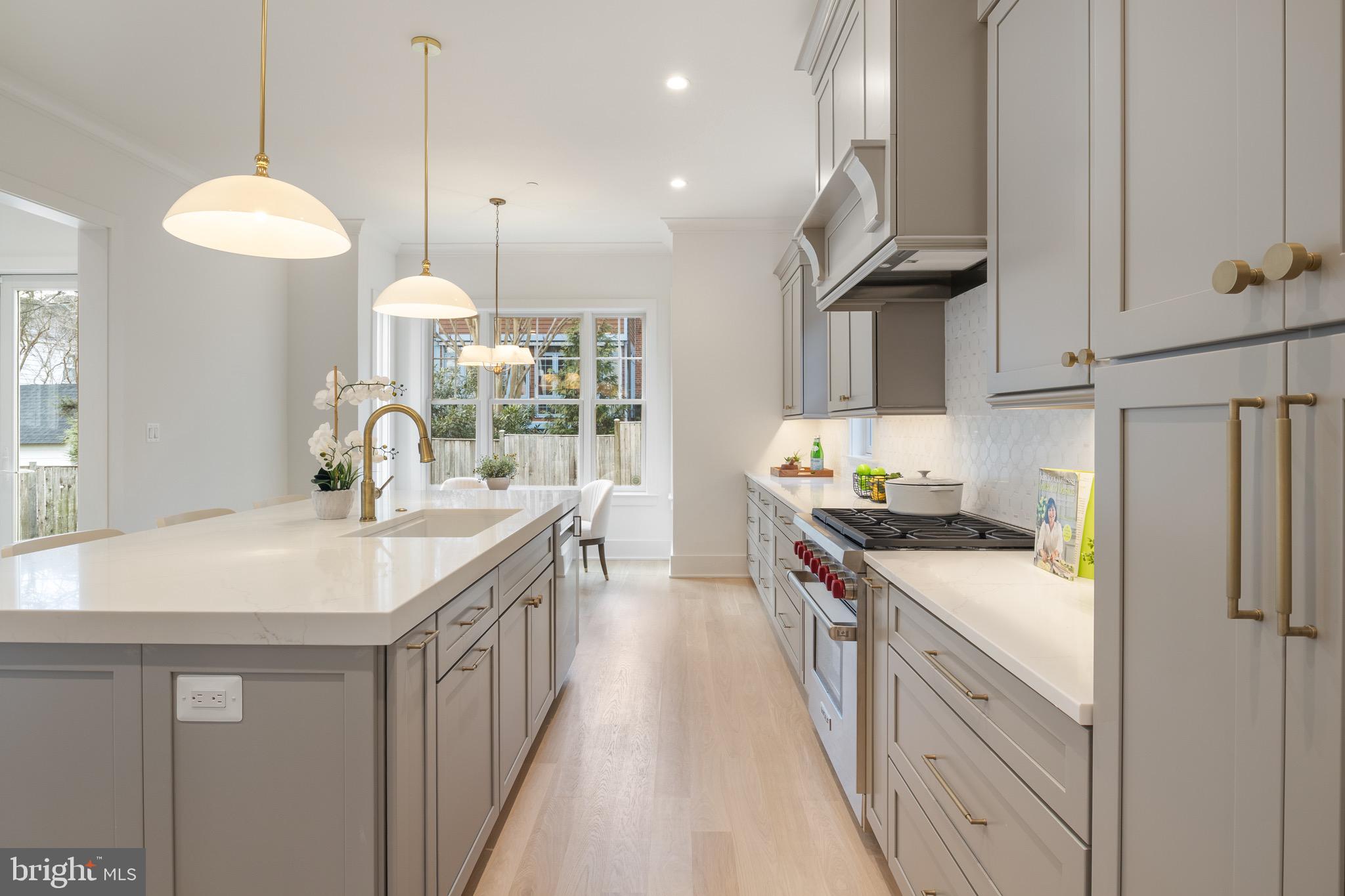 7804 Custer Road Bethesda, MD 20814 - Photo 26 of 68 a kitchen with stainless steel appliances granite countertop a sink a stove and a wooden floors
