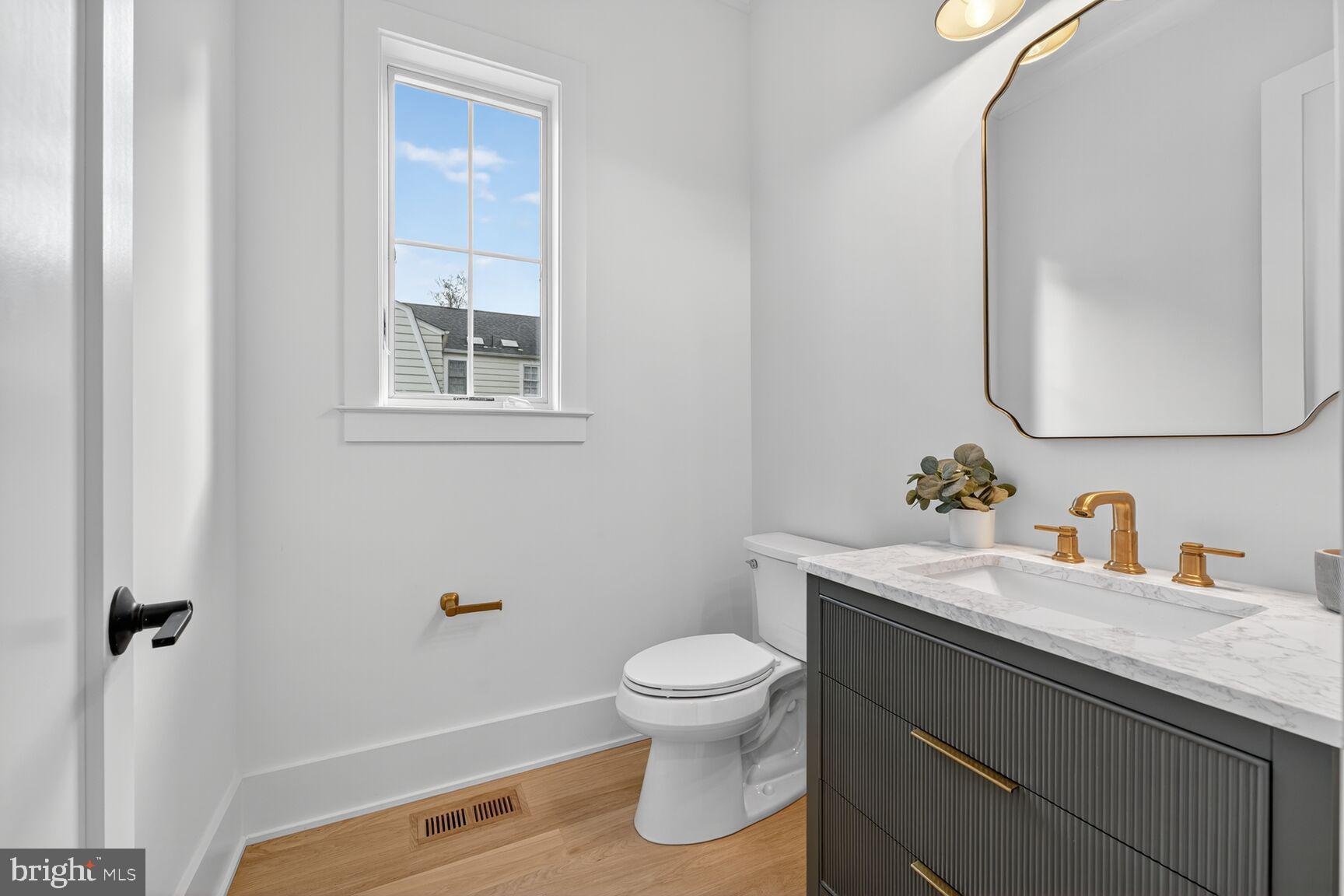 7804 Custer Road Bethesda, MD 20814 - Photo 34 of 68 a bathroom with a sink a toilet and a mirror
