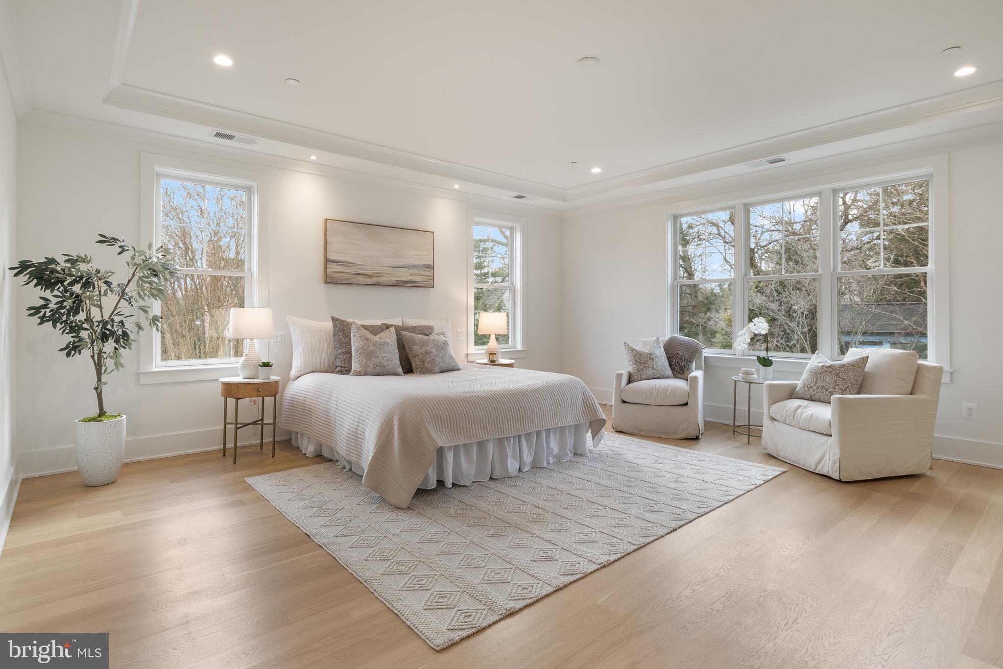 7804 Custer Road Bethesda, MD 20814 - Photo 35 of 68 a spacious bedroom with a large bed and a couch