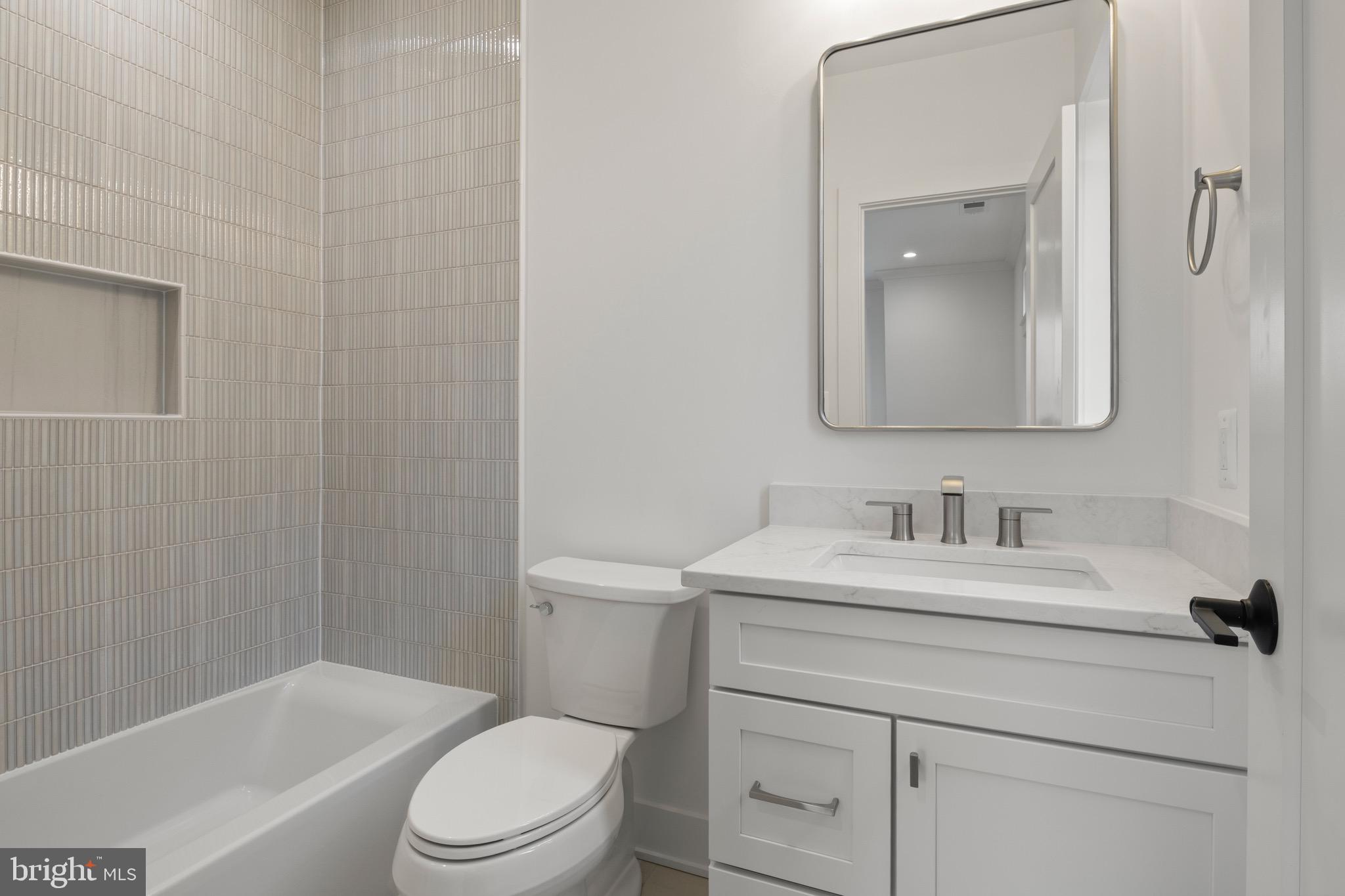 7804 Custer Road Bethesda, MD 20814 - Photo 47 of 68 a bathroom with a sink toilet vanity and tub