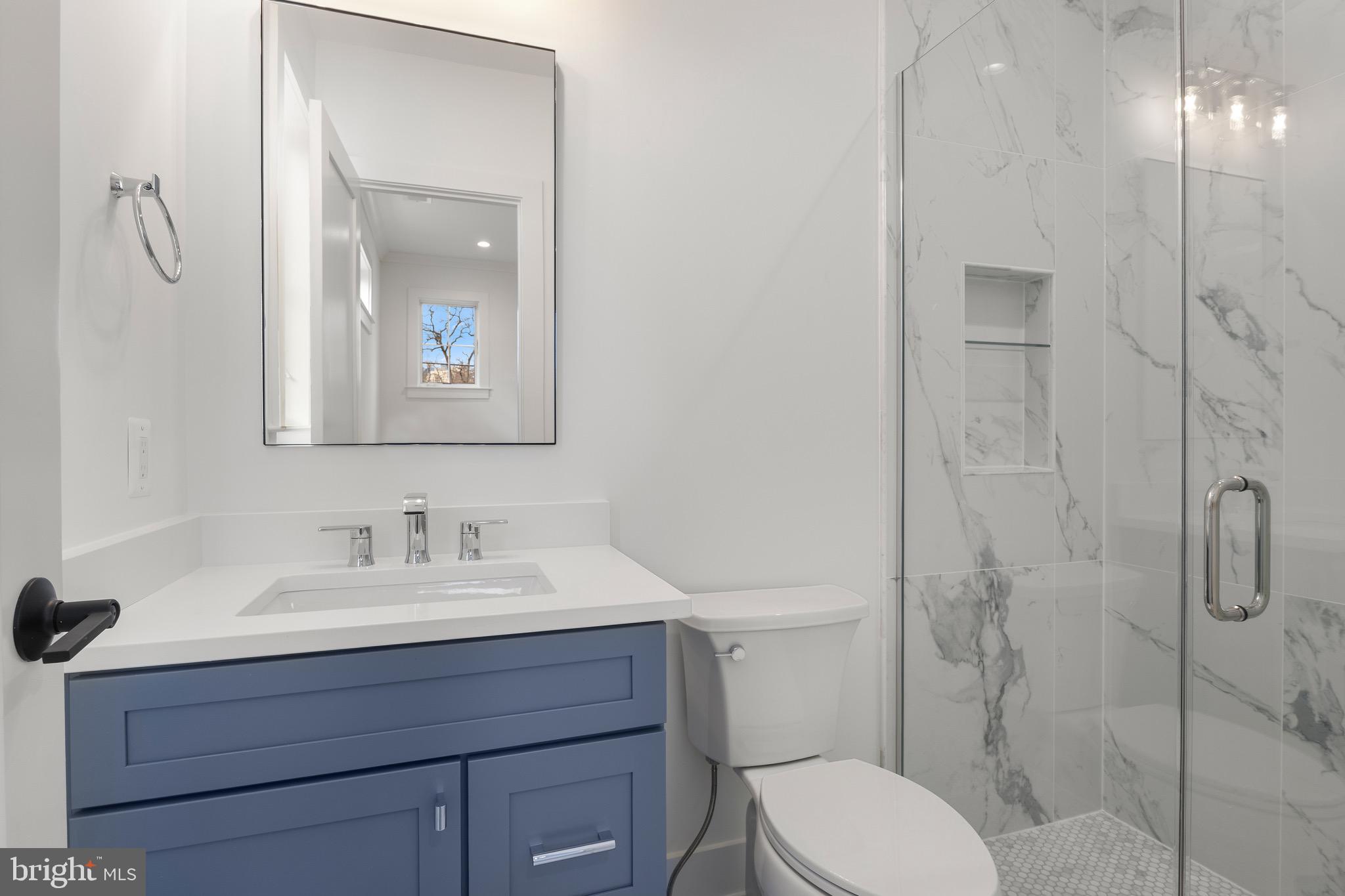 7804 Custer Road Bethesda, MD 20814 - Photo 49 of 68 a bathroom with a sink toilet and shower