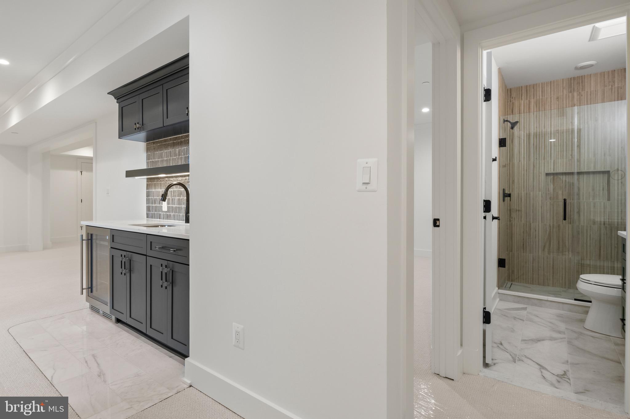 7804 Custer Road Bethesda, MD 20814 - Photo 57 of 68 a bathroom with a granite countertop sink a toilet and shower