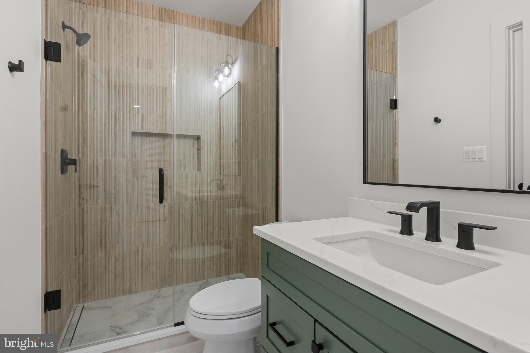 7804 Custer Road Bethesda, MD 20814 - Photo 59 of 68 a bathroom with a sink a toilet and shower