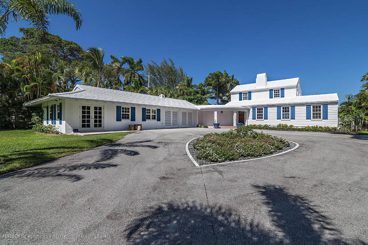 3130 Washington Road West Palm Beach, FL 33405 - Photo 1 of 33 a view of a white house with a yard and potted plants