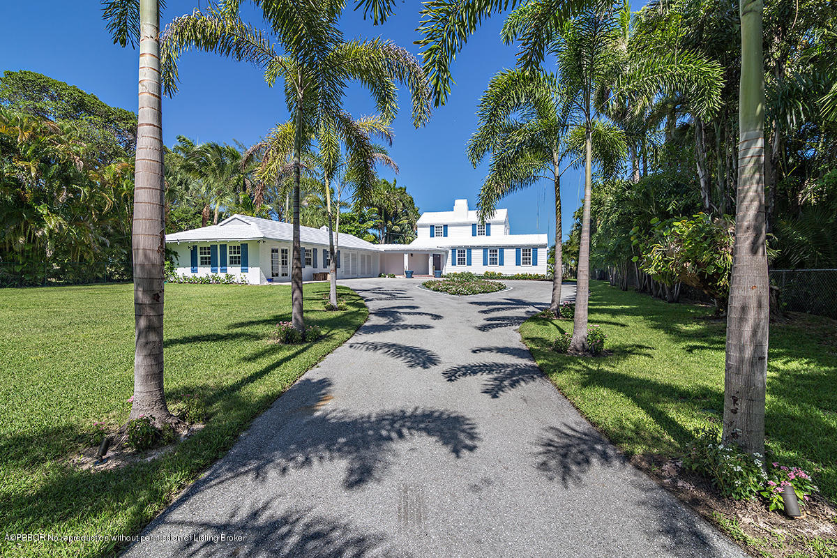 3130 Washington Road West Palm Beach, FL 33405 - Photo 2 of 33 a view of a house with a yard and palm trees