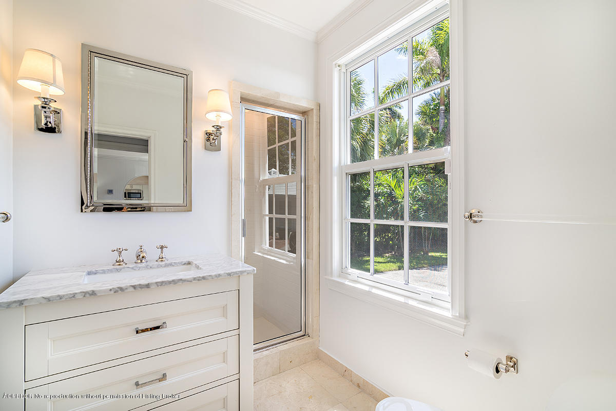 3130 Washington Road West Palm Beach, FL 33405 - Photo 12 of 33 a bathroom with a sink and a mirror