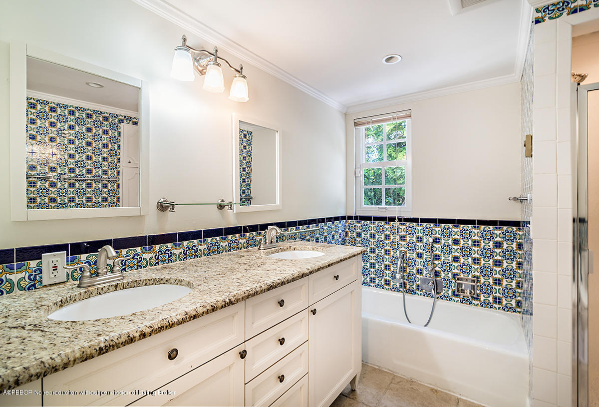3130 Washington Road West Palm Beach, FL 33405 - Photo 14 of 33 a bathroom with a granite countertop sink a mirror a and a bathtub