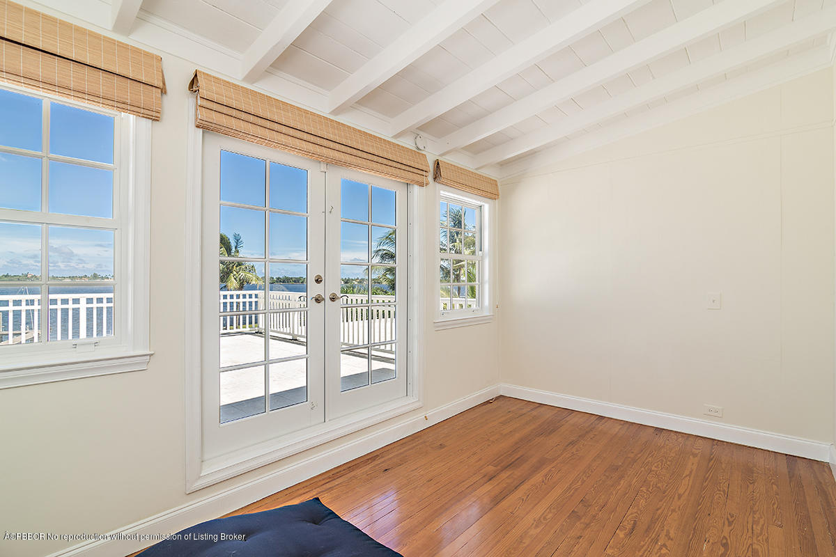 3130 Washington Road West Palm Beach, FL 33405 - Photo 16 of 33 an empty room with wooden floor and windows