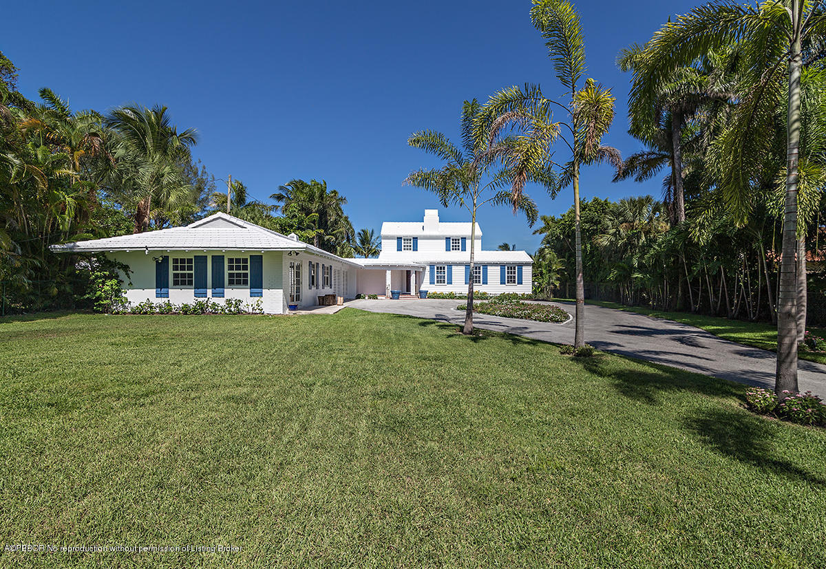 3130 Washington Road West Palm Beach, FL 33405 - Photo 3 of 33 a front view of a house with garden