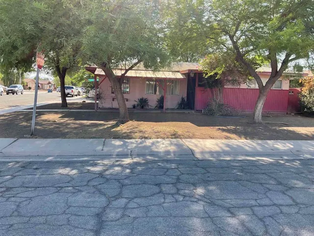a view of a house with a yard covered with snow