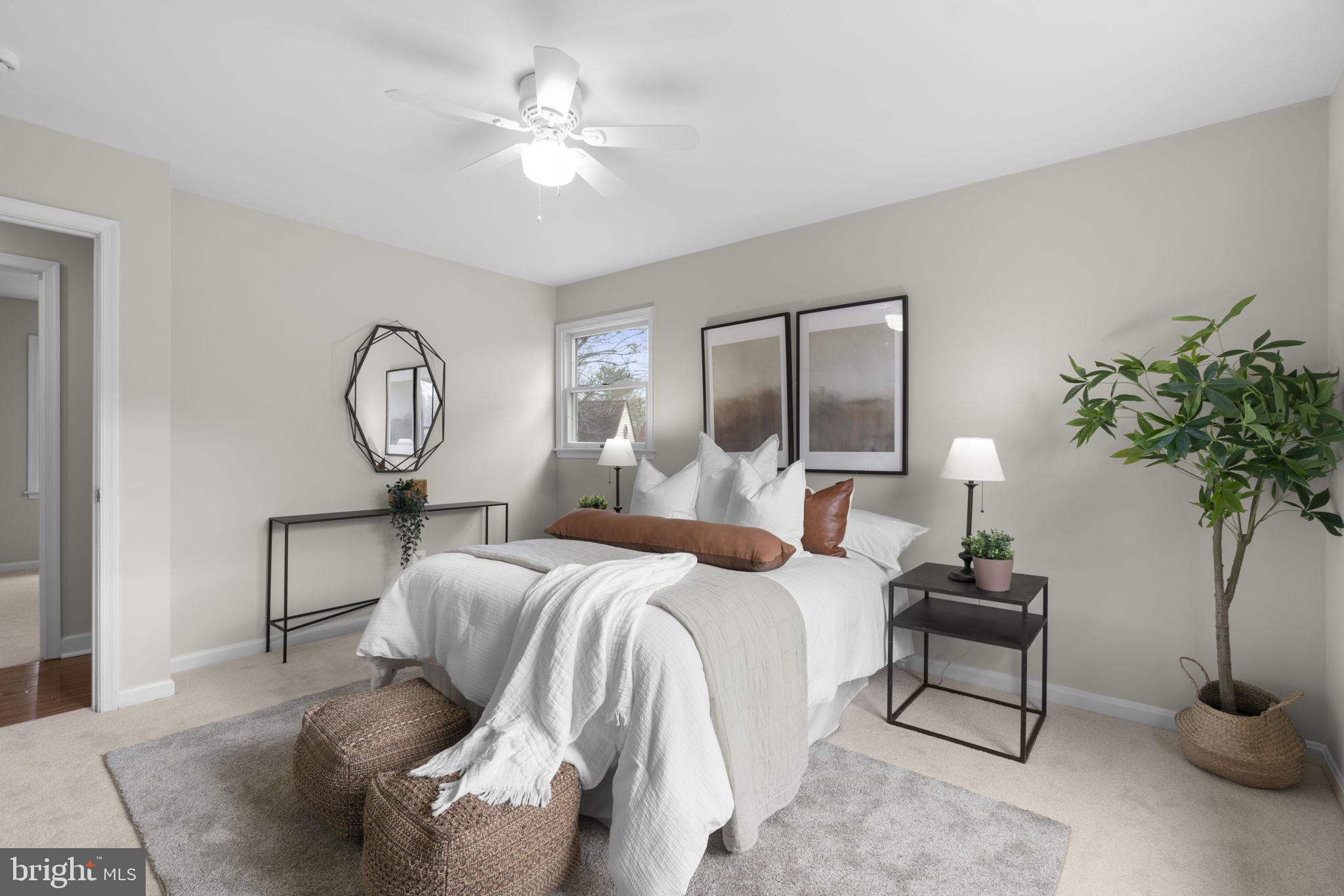 6968 Sunfleck Row Columbia, MD 21045 - Photo 16 of 45 a bedroom with bed and a potted plant