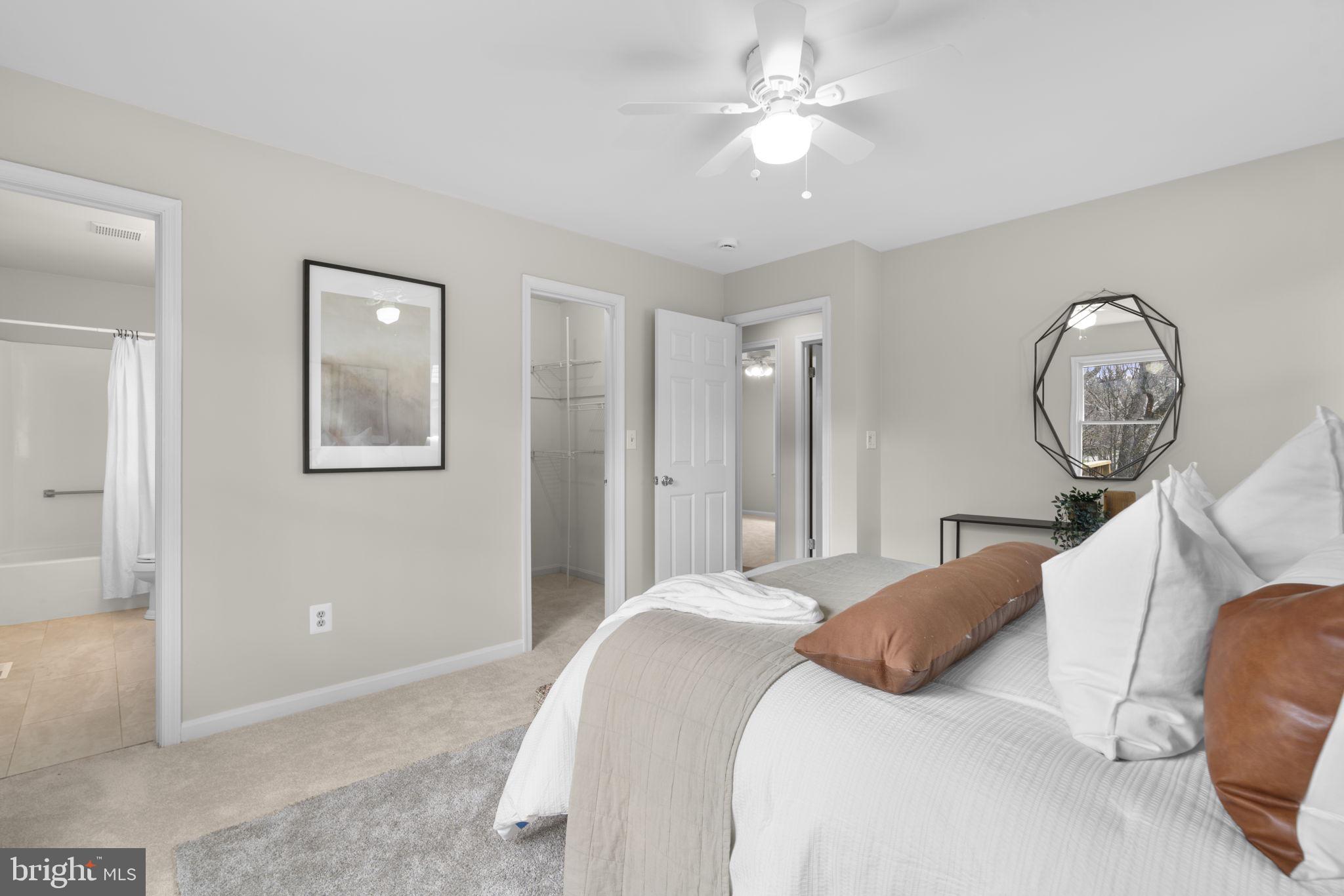 6968 Sunfleck Row Columbia, MD 21045 - Photo 17 of 45 a bedroom with a large bed and a chandelier