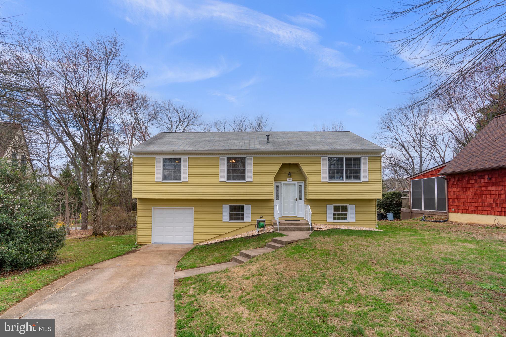 6968 Sunfleck Row Columbia, MD 21045 - Photo 2 of 45 a front view of a house with a yard