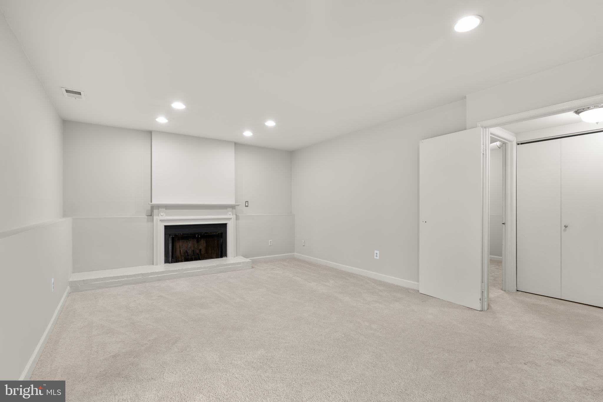 6968 Sunfleck Row Columbia, MD 21045 - Photo 26 of 45 a view of an empty room with a fireplace