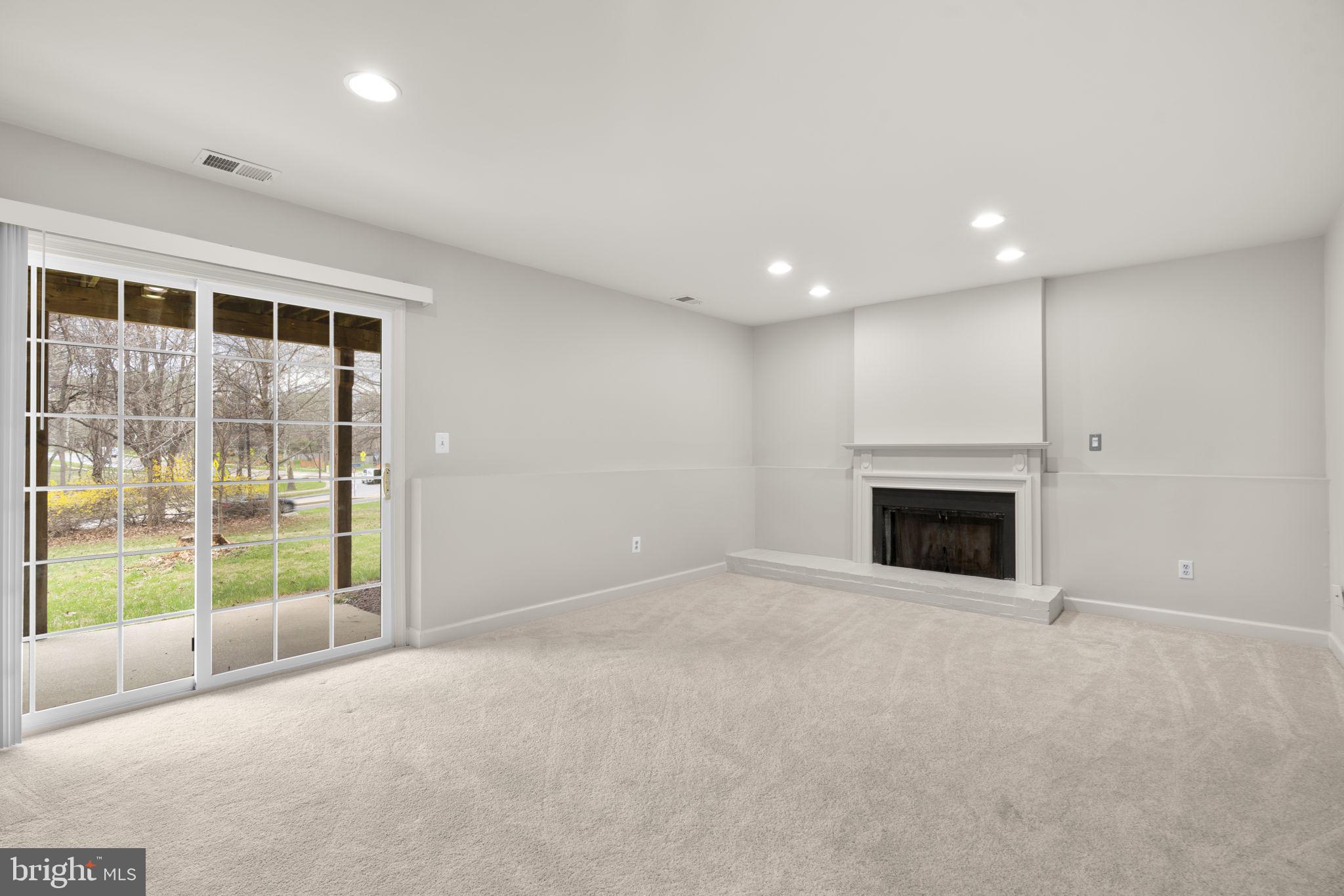 6968 Sunfleck Row Columbia, MD 21045 - Photo 27 of 45 a view of an empty room with a fireplace