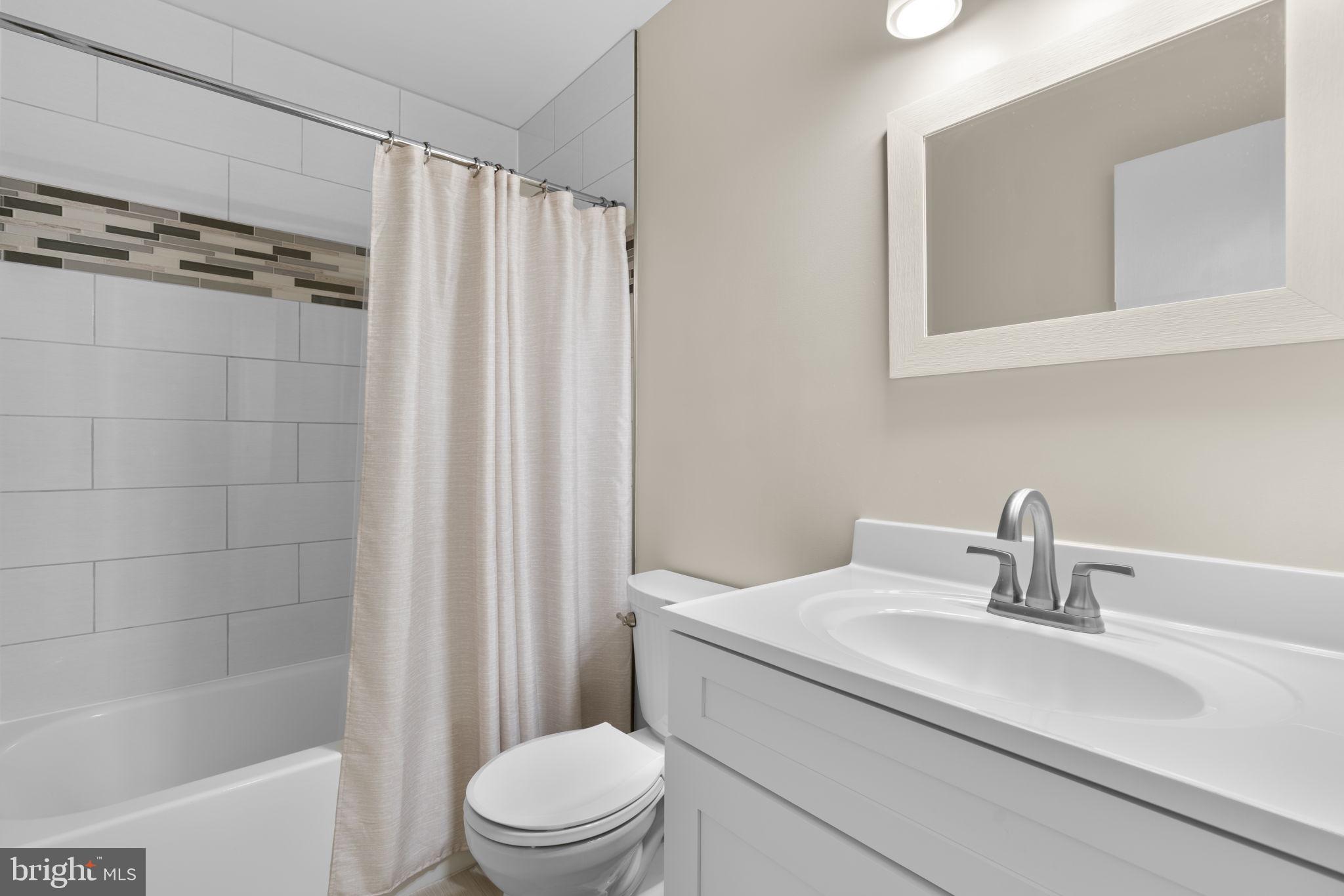 6968 Sunfleck Row Columbia, MD 21045 - Photo 32 of 45 a bathroom with a sink a toilet and shower