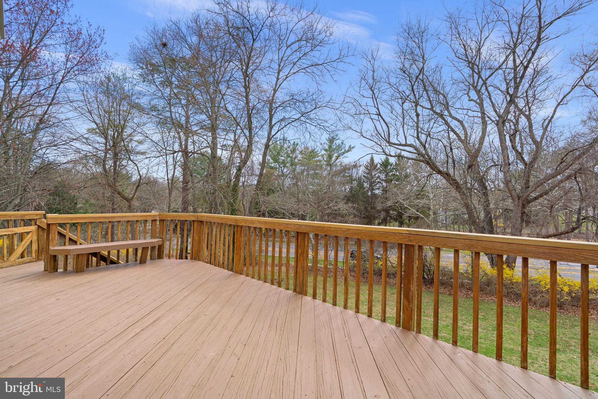 6968 Sunfleck Row Columbia, MD 21045 - Photo 39 of 45 a view of balcony with wooden floor and fence