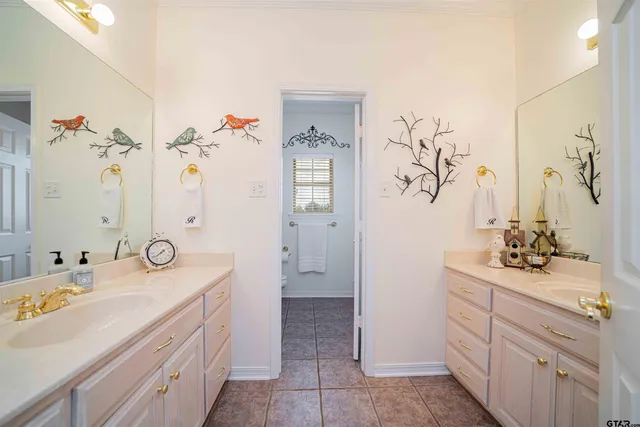 a bathroom with a double vanity sink and mirror