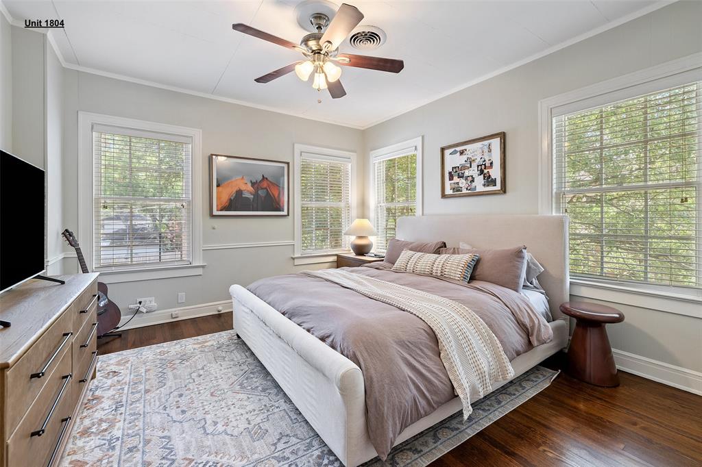 1806 Pearl Street Austin, TX 78701 - Photo 13 of 19 Hardwood flooring complemented by multiple windows with blinds, a ceiling fan, crown molding, and baseboards