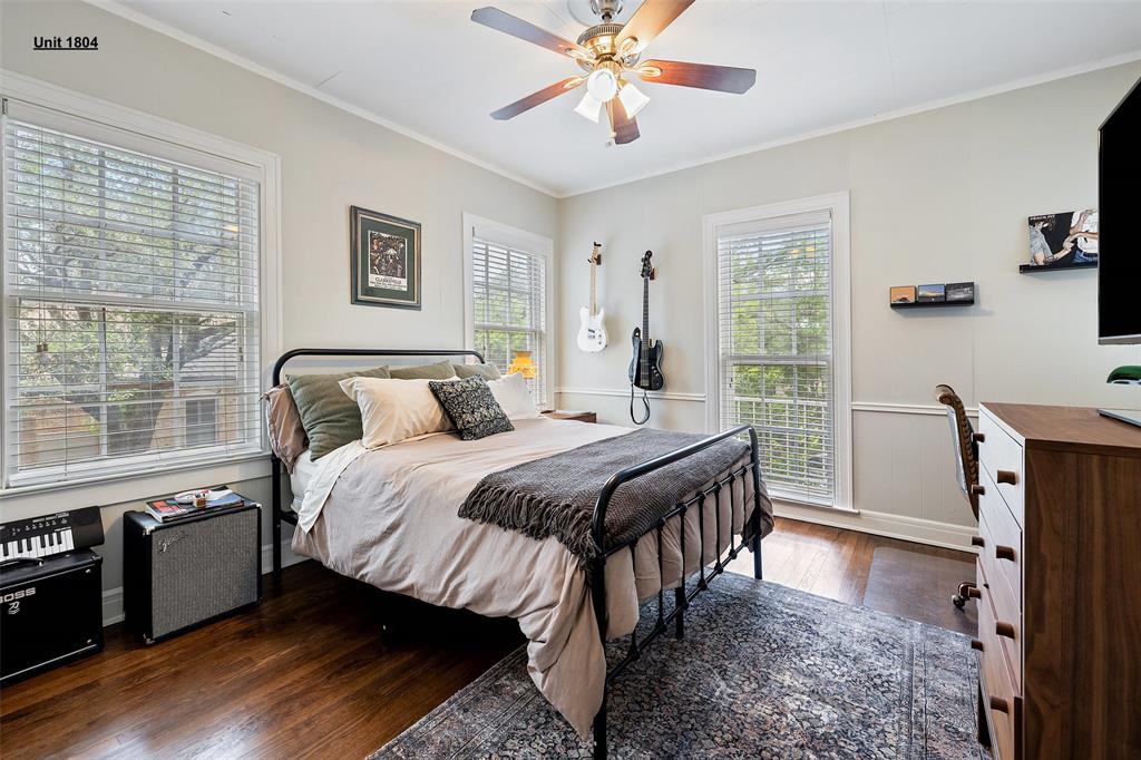 1806 Pearl Street Austin, TX 78701 - Photo 14 of 19 Bright room featuring rich wood-finish flooring, multiple windows with blinds, crown molding, and wainscoting