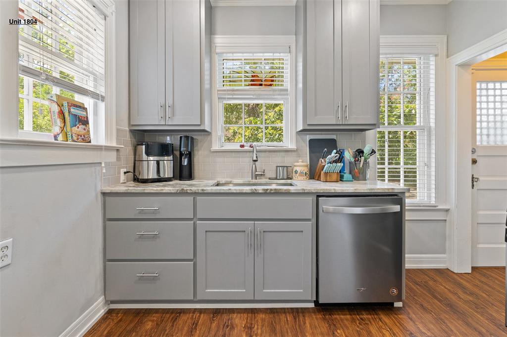 1806 Pearl Street Austin, TX 78701 - Photo 3 of 19 Kitchenette with gray cabinetry, light stone-finish countertops, and a subway tile backsplash