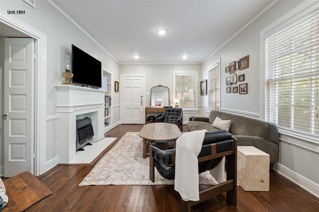 1806 Pearl Street Austin, TX 78701 - Photo 5 of 19 Living area featuring dark wood-finish flooring, a white mantel, recessed lighting, and multiple windows with blinds