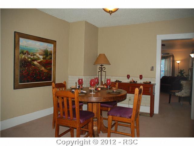 110 West Cheyenne Road Colorado Springs, CO 80906 - Photo 2 of 25 Dining Room in the main house, filled with brick accents, retaining the turn of the century victorian charm.
