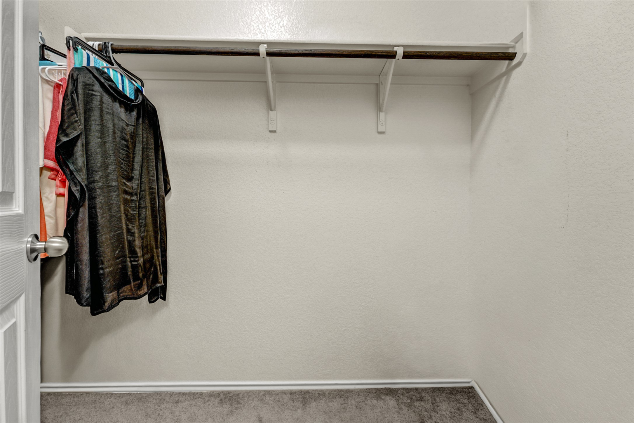 213 Ibis Falls Loop Jarrell, TX 76537 - Photo 20 of 37 A deep walk-in closet with ample hanging space and a neutral color palette awaits personalization.