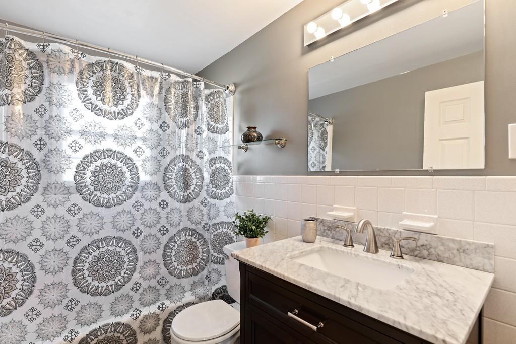 294 Salem Road Billerica, MA 01821 - Photo 11 of 25 a bathroom with a granite countertop sink and a mirror
