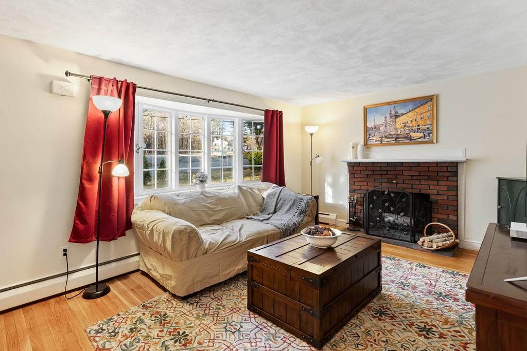 294 Salem Road Billerica, MA 01821 - Photo 13 of 25 a living room with furniture and a fireplace
