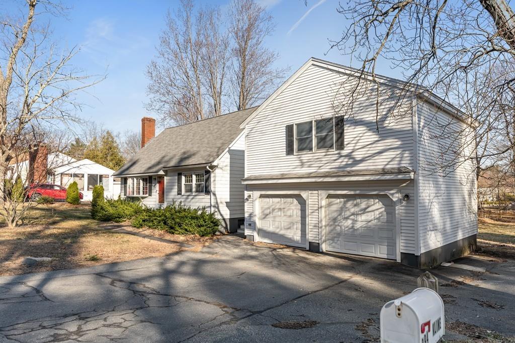 294 Salem Road Billerica, MA 01821 - Photo 3 of 25 a view of a white house with a road