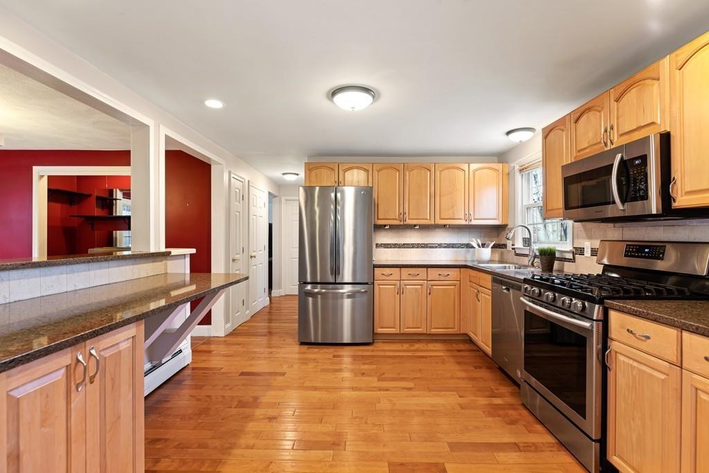 294 Salem Road Billerica, MA 01821 - Photo 5 of 25 a kitchen with stainless steel appliances granite countertop a stove top oven a sink and a refrigerator