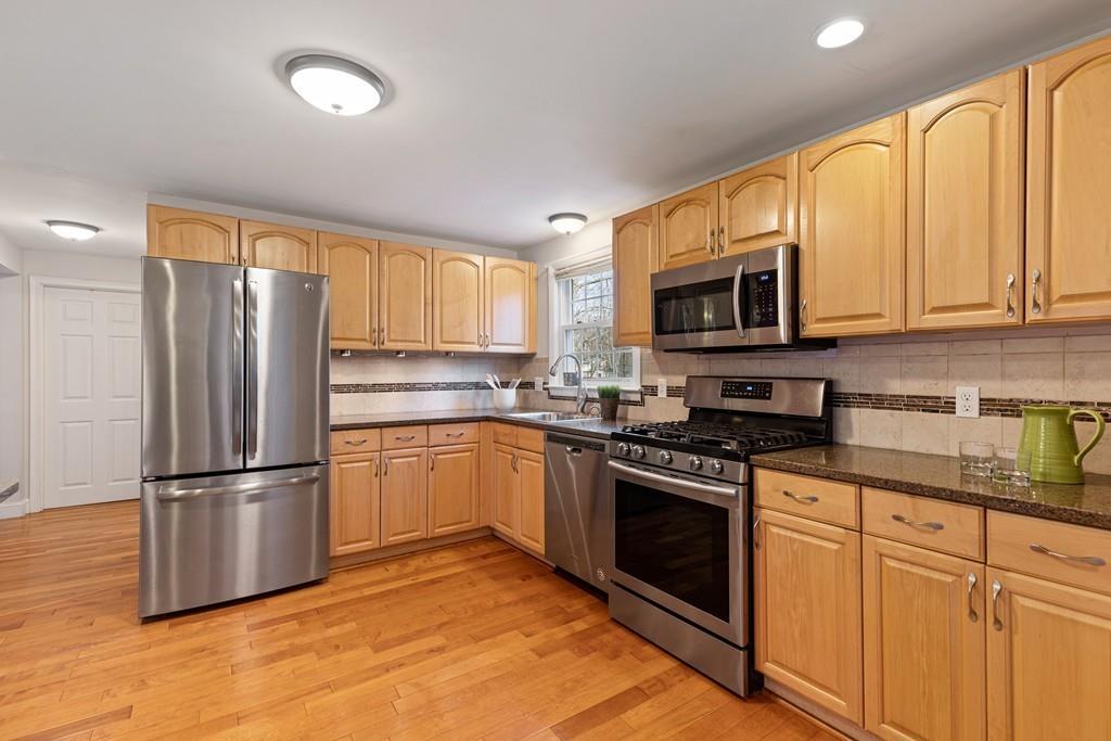 294 Salem Road Billerica, MA 01821 - Photo 7 of 25 a kitchen with granite countertop a refrigerator stove top oven and sink