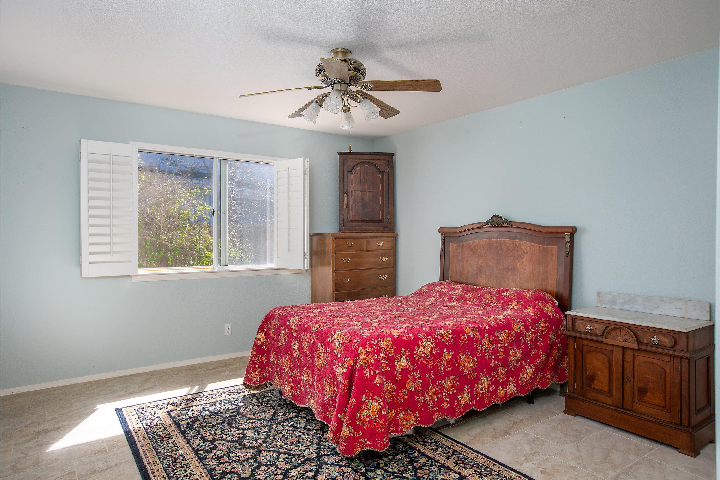 3376 Shepherd Drive Lompoc, CA 93436 - Photo 17 of 27 a bedroom with a bed and a chandelier