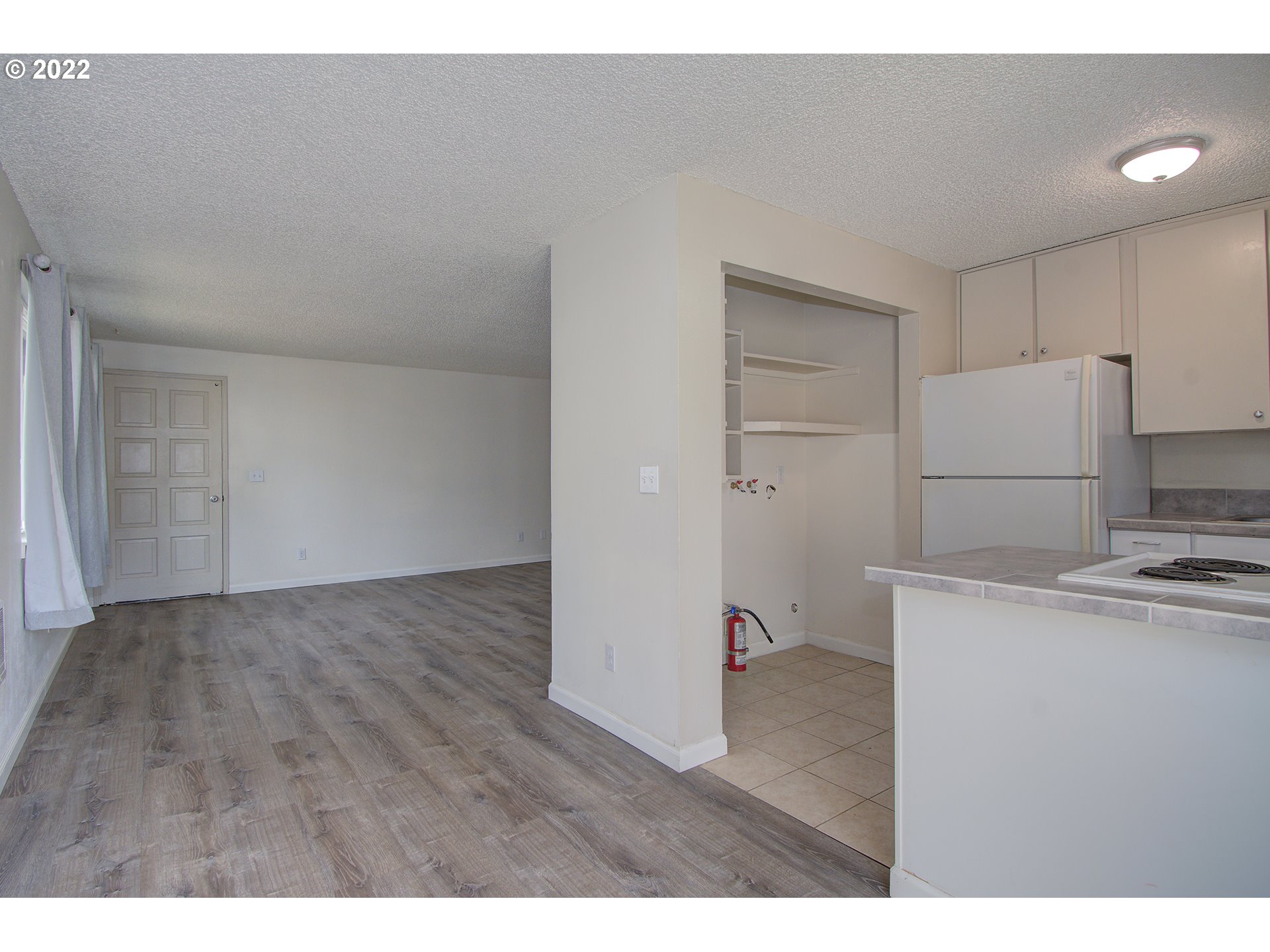 2912 R Street Vancouver, WA 98663 - Photo 12 of 24 a view of a kitchen with a sink dishwasher and a refrigerator