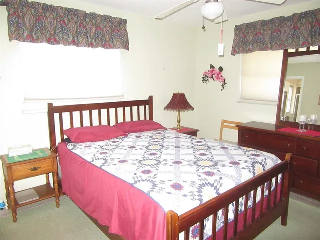 a bed sitting in a bedroom next to a window