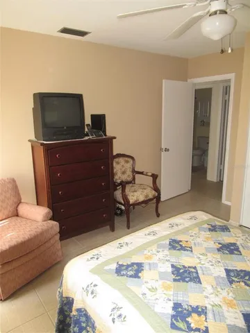 a bedroom with a bed and a television