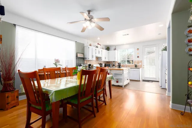 a kitchen with stainless steel appliances white cabinets a sink and a stove